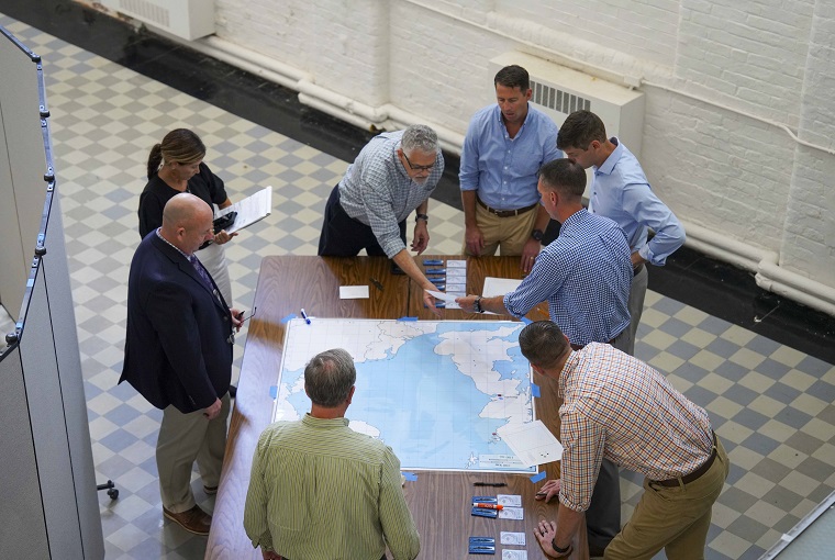 A group of people around a map